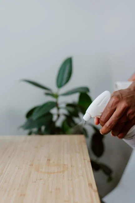 Side view of young male employee holding stack of white towels while standing in bathroom of luxury hotel
